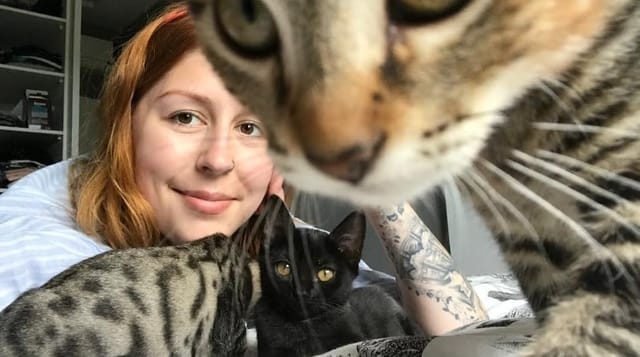 Lígia at home with several cats